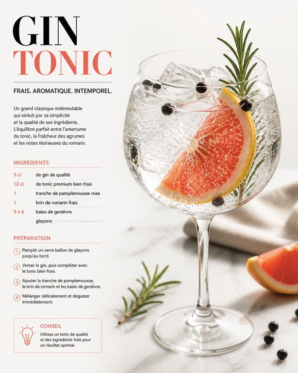 Cocktail Gin Tonic signature avec pamplemousse et romarin dans un verre ballon